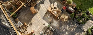 a team of skilled carpenters working on a spacious, well-designed outdoor patio, surrounded by neatly stacked wood and high-quality tools.